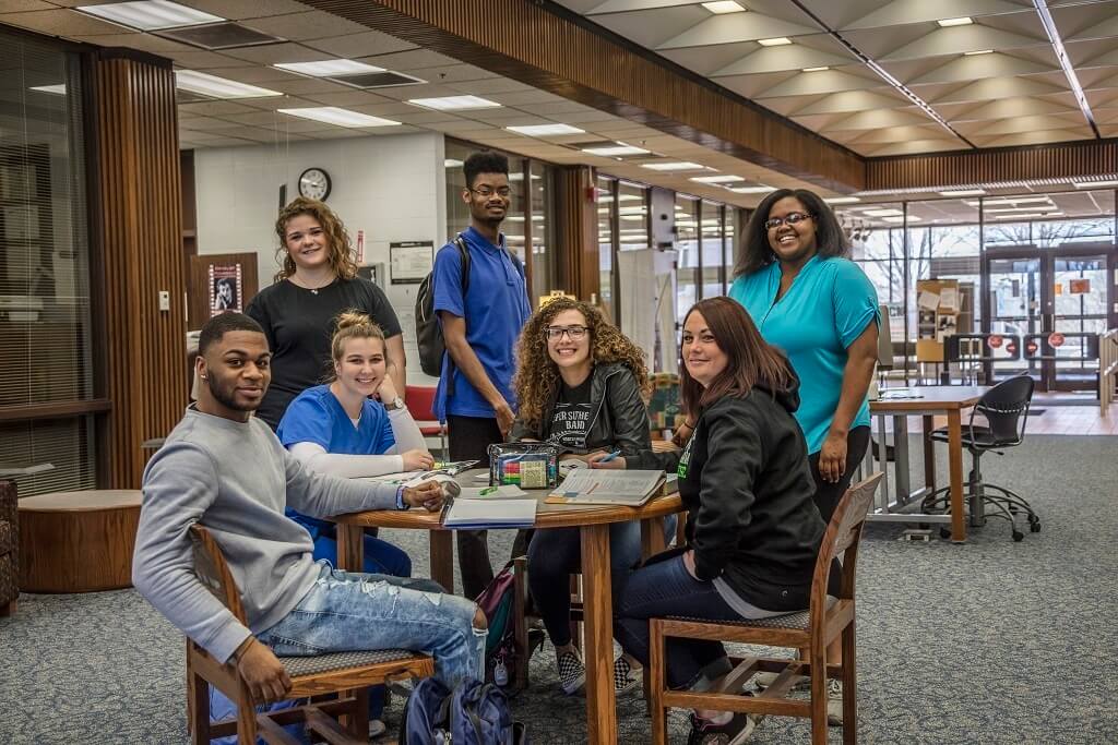 students gathered at library table