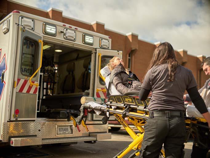 EMT students practicing loading someone in an ambulance. 